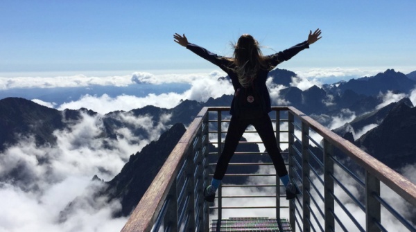 Woman at top of mountain