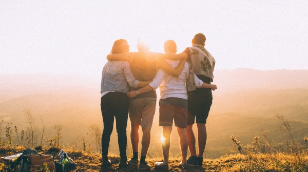 team with arms round each other